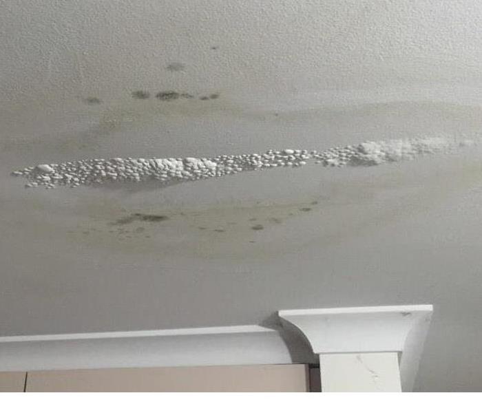 Ceiling with bubbling paint from water damage