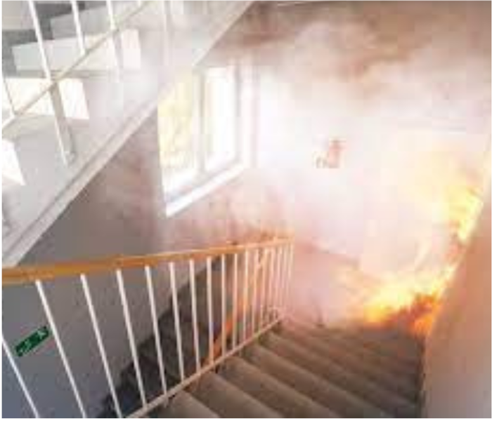 Smoke billowing up the stairs