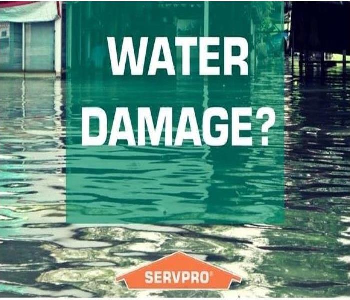 SERVPRO water damage advertisement set in from of a puddle of water